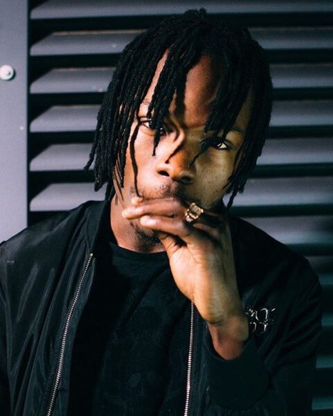 Naira Marley reacts to Viral Photo Of A Look-Alike Posing With A Naked Woman