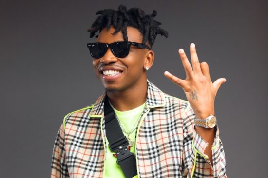 Mayorkun reacts as lady tattoos his face on her stomach