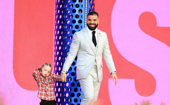 Drake accepts the Billboard Music Awards Artist of the Decade award with his son Adonis onstage.