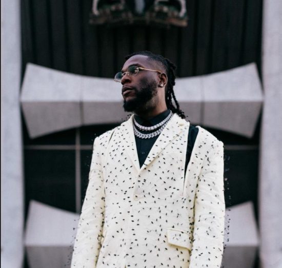 Burna Boy uses his Grammy plaque to drinks champagne in the club