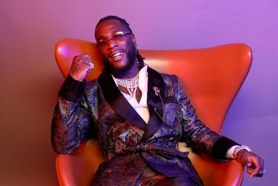 Burna Boy uses his Grammy plaque to drinks champagne in the club