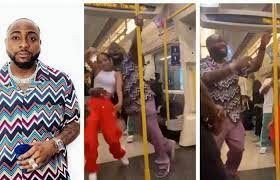 Fans reacted to Davido dancing in a train with an unknown lady in London