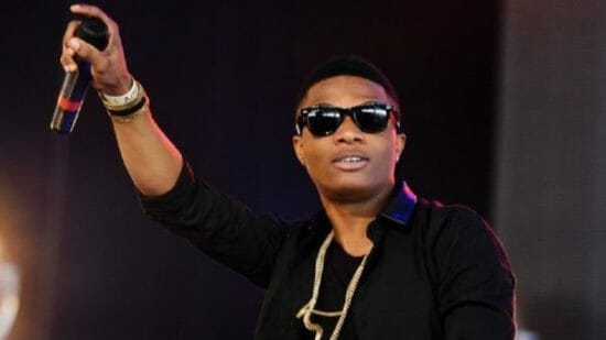 Watch as a fan drags Wizkid to the floor during a performance