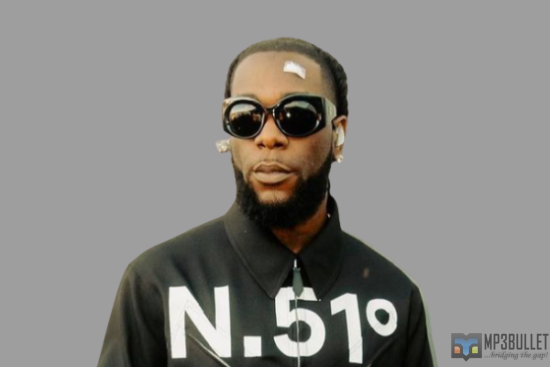 Burna Boy receives a'Igbo and Shayo' pendant from a white fan.